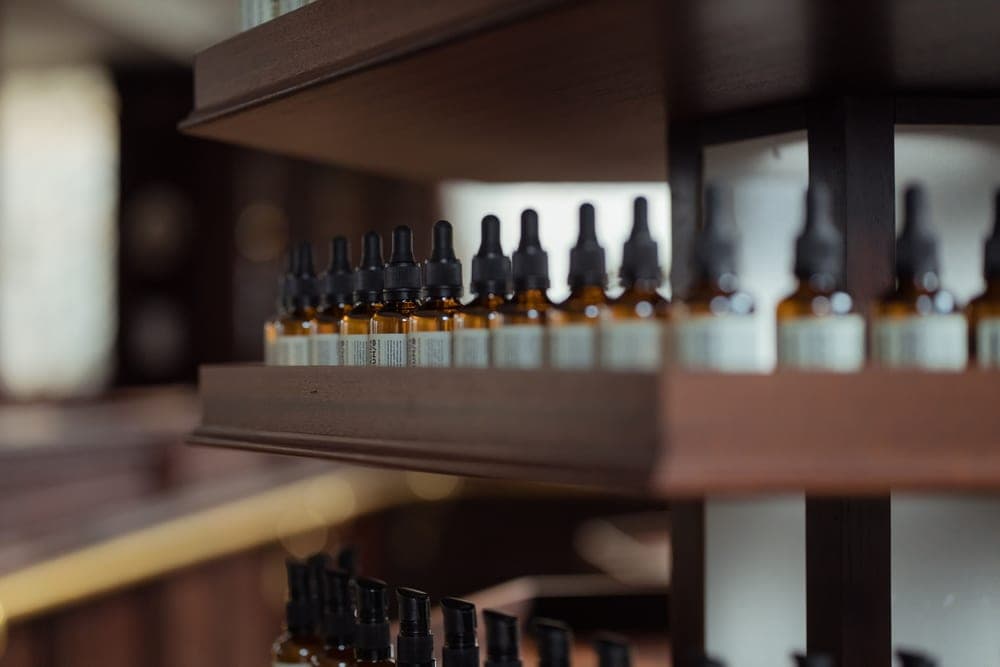 A dropper bottle of beard oil on a wooden surface