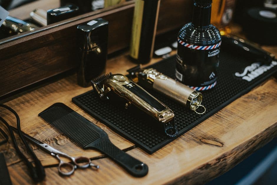 Barber tools including clippers on a wooden table