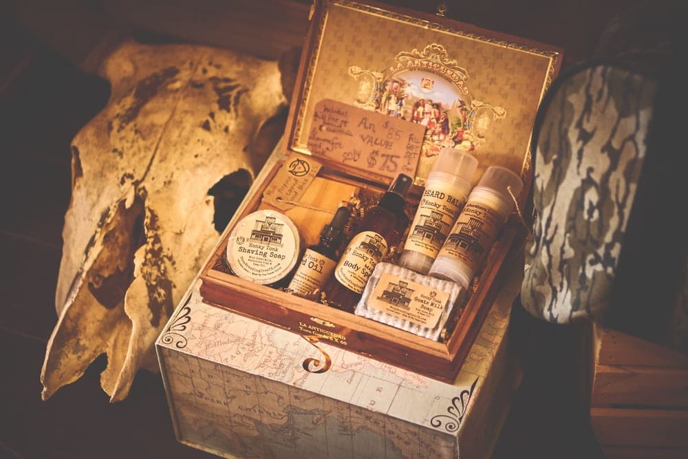A tin of beard balm beside a bottle of beard oil