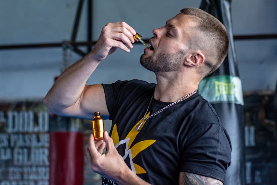 A bottle of beard oil with a dropper
