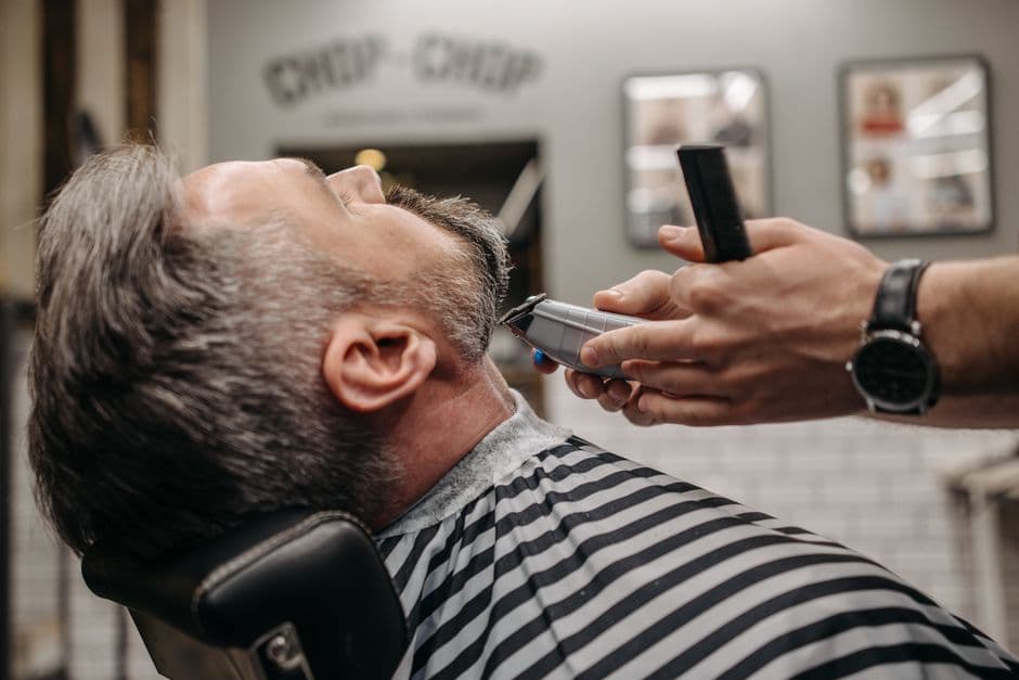 A beard trimmer with a length adjustment dial