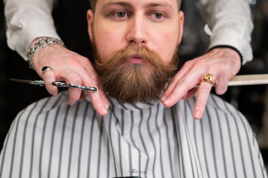 Beard scissors and a comb on a counter