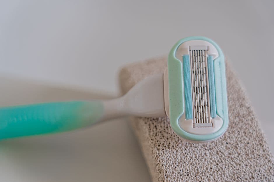 A long-handled back shaver in a bathroom