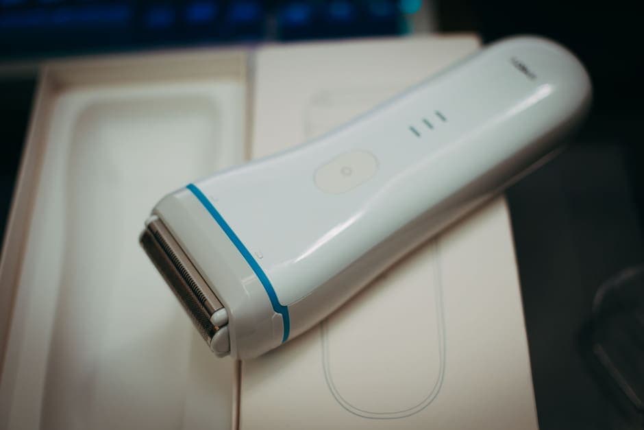 An electric shaver resting on its packaging