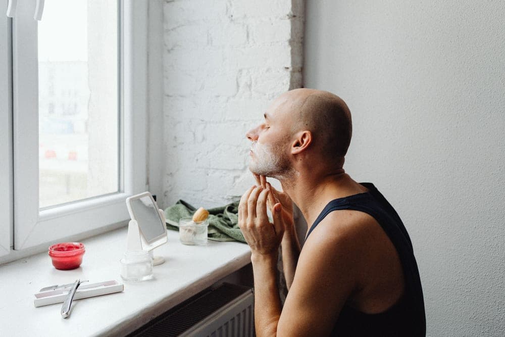 A man touching his jawline after shaving