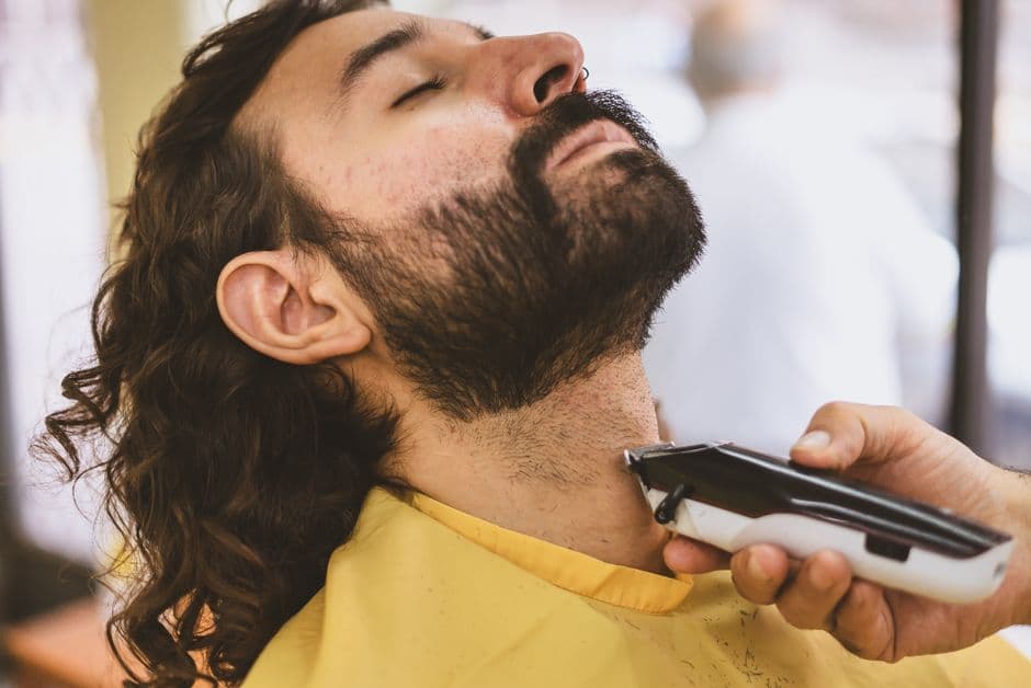 A beard being trimmed with an electric trimmer