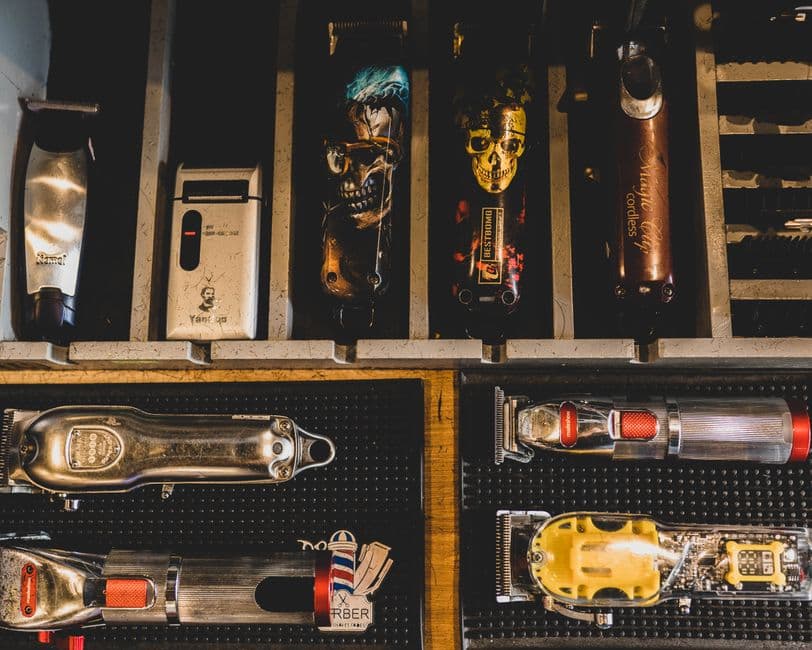 A corded metal clipper on a barber station