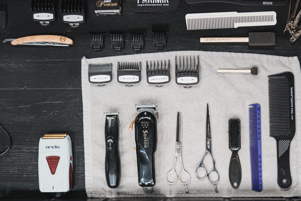 Hair clippers with attachment guards laid out on a surface