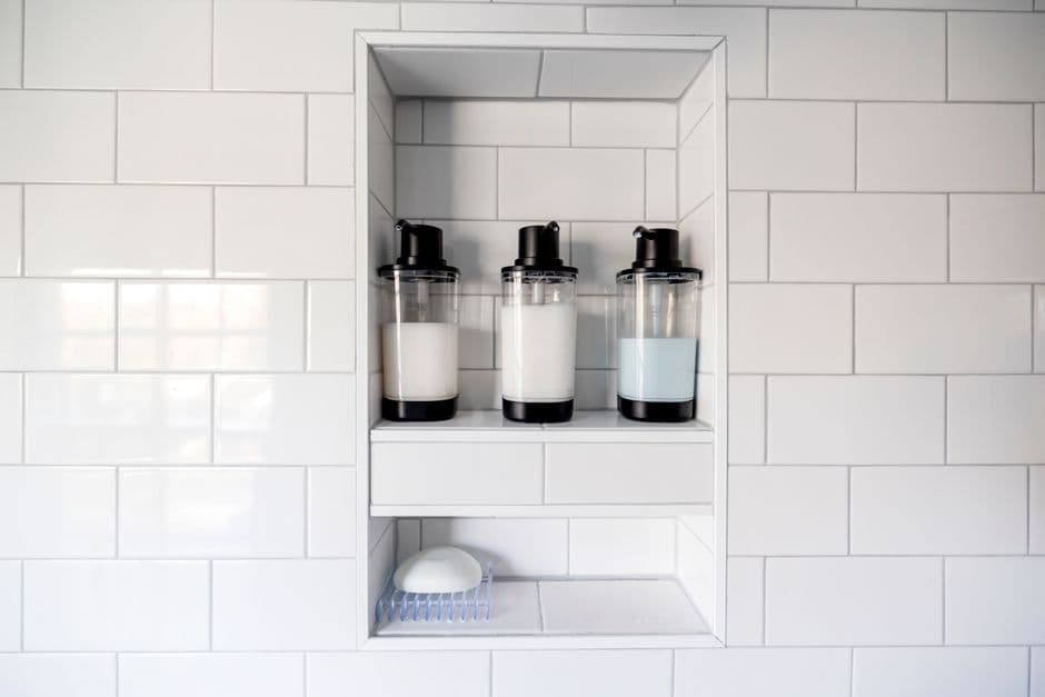 Shampoo bottles on a shower shelf