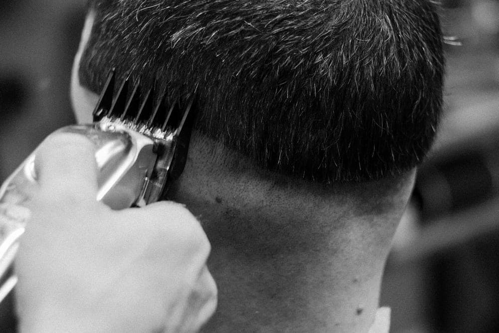 A close taper fade at the back of a man's head