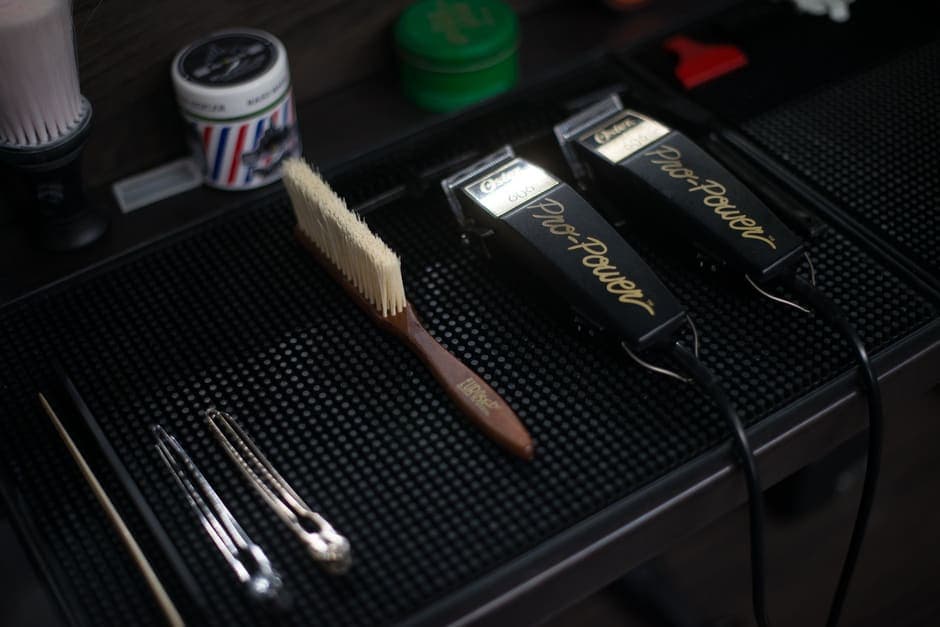 Hair clippers and grooming tools laid out in a barbershop