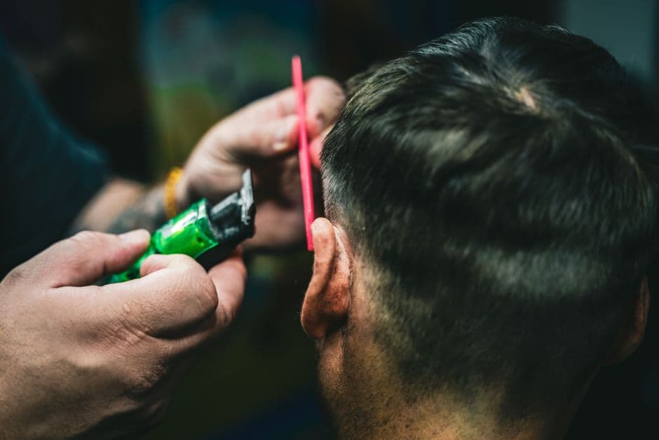 The back of a man's neck being trimmed
