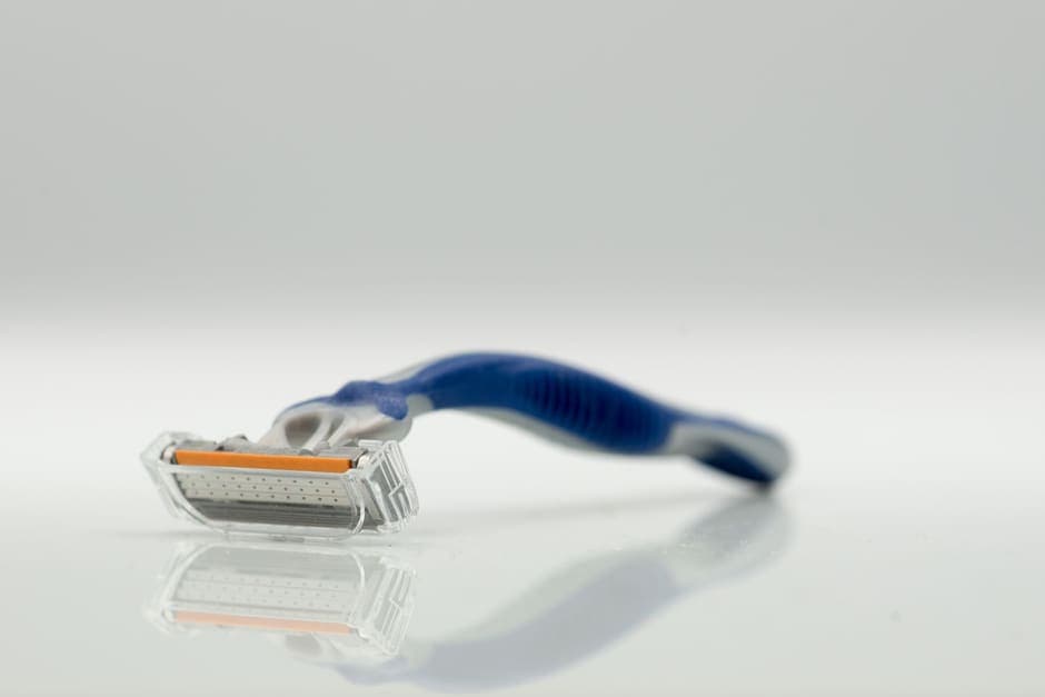 A cartridge razor on a pale reflective surface