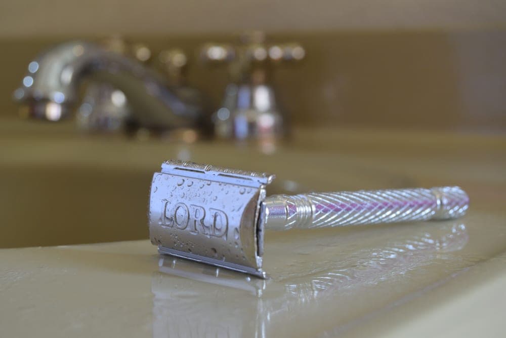 The head of a heavy chrome safety razor in close detail