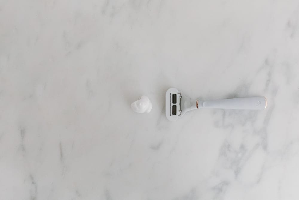 A mild closed-comb safety razor on a pale surface
