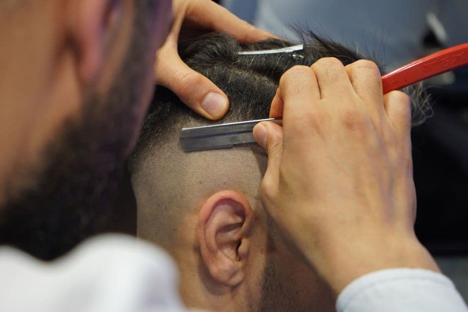 A barber using a straight razor