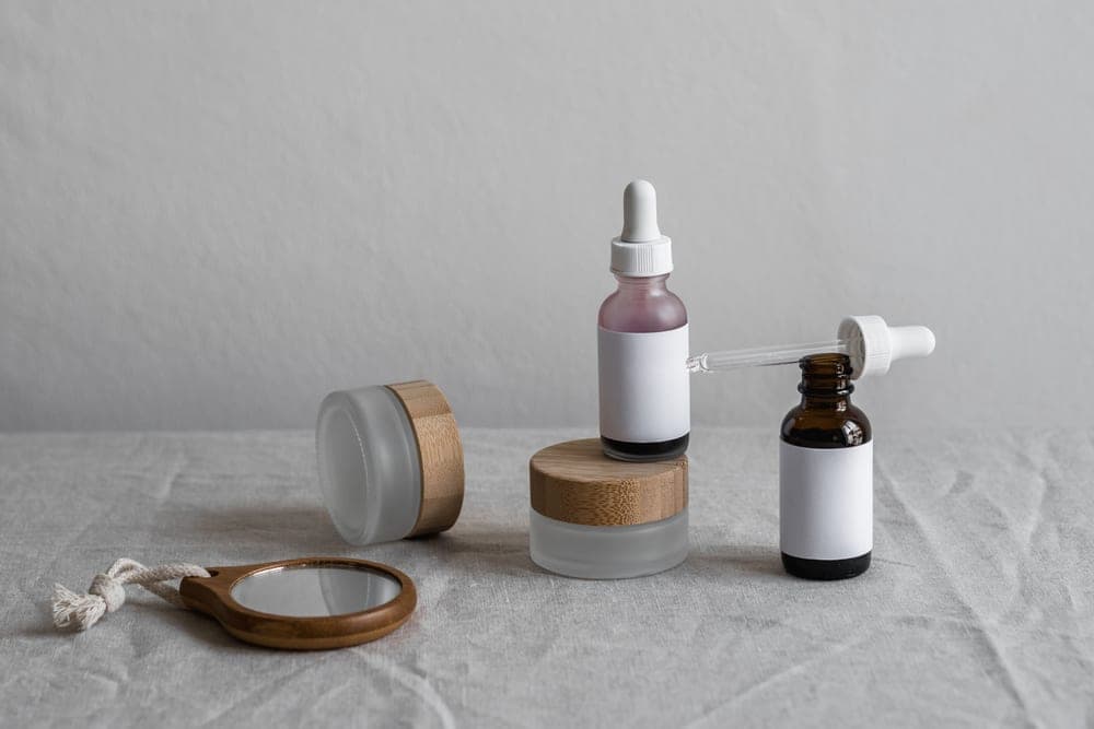 Two plain skincare bottles standing side by side