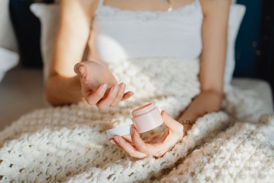 A jar of moisturizing cream on a bathroom counter