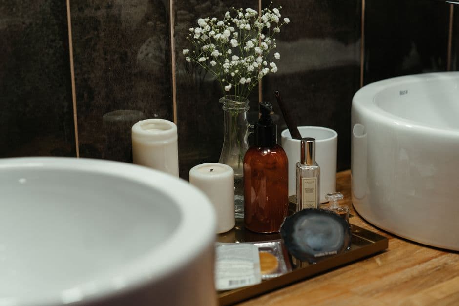 Skincare products lined up on a bathroom counter