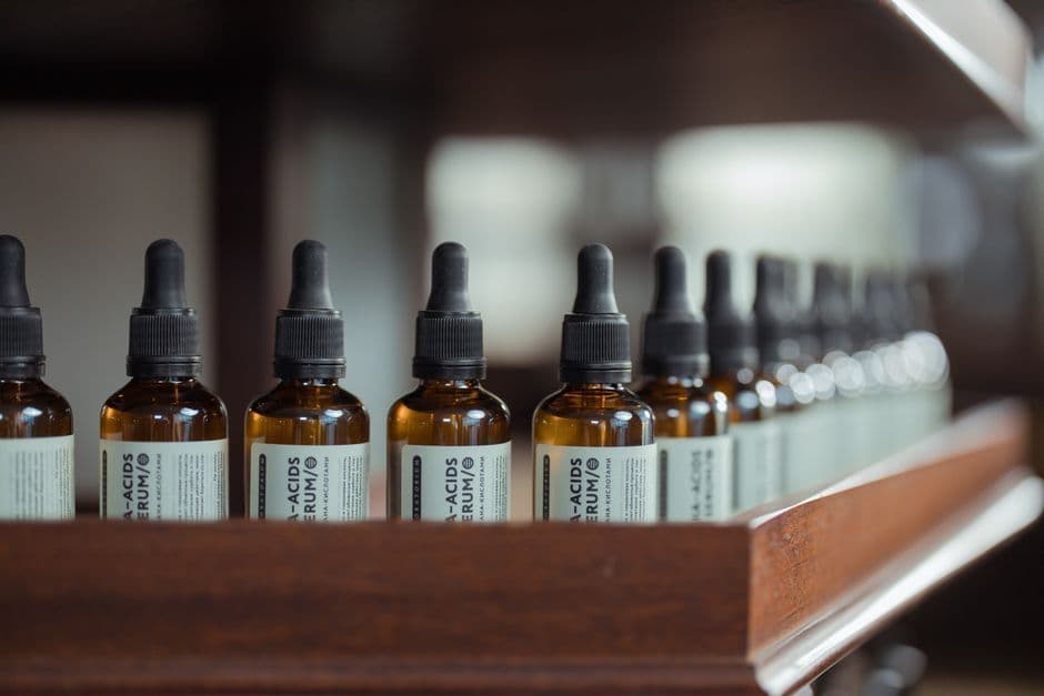 Two serum bottles on a bathroom shelf